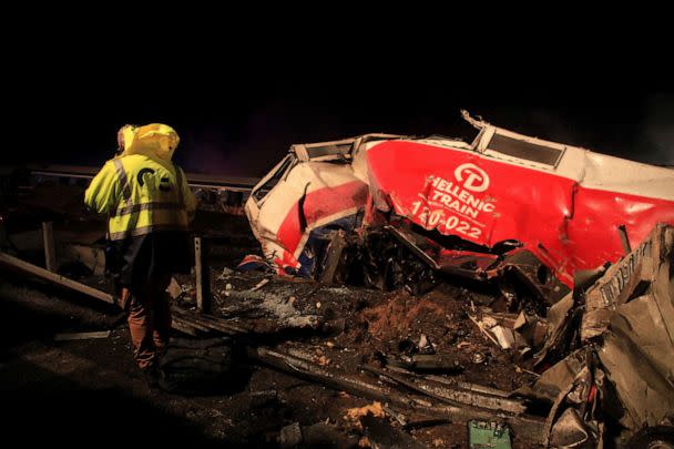 PHOTO: A man walks at the site of a crash, where two trains collided, near the city of Larissa, Greece, March 1, 2023. (Kostas Mantziaris/Reuters)