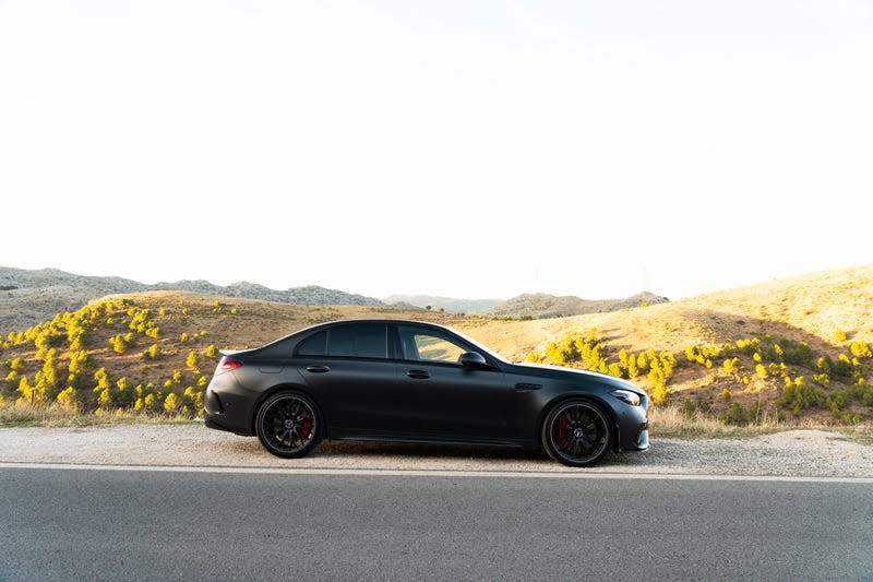 2023 mercedes-amg c 63 s e-performance in matte black photographed on the side of a mountain road in spain