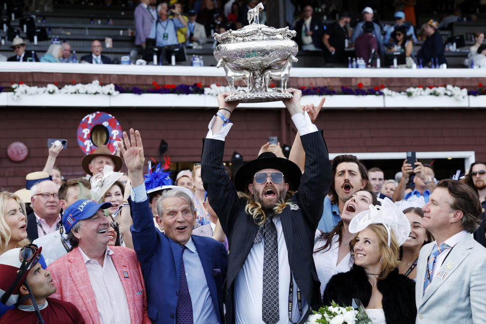 SARATOGA SPRINGS, NEW YORK - JUNE 08: Owner Jayson Werth (C) raises the trophy after Dornoch with Luis Saez up wins the 156th running of the Belmont Stakes at Saratoga Race Course on June 08, 2024 in Saratoga Springs, New York.  The race was moved to Saratoga while Belmont Park undergoes renovations. (Photo by Sarah Stier/Getty Images)