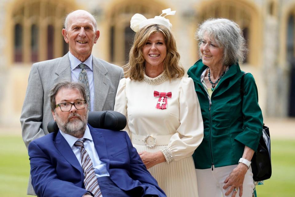 Kate Garraway with Derek Draper and her parents Gordon and Marilyn Garraway, as she poses after being appointed an MBE at Windsor Castle on June 28, 2023 (POOL/AFP via Getty Images)