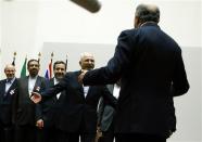 Iranian Foreign Minister Mohammad Javad Zarif (4th L) hugs French Foreign Minister Laurent Fabius (R, back facing camera) after a ceremony at the United Nations in Geneva November 24, 2013. REUTERS/Denis Balibouse