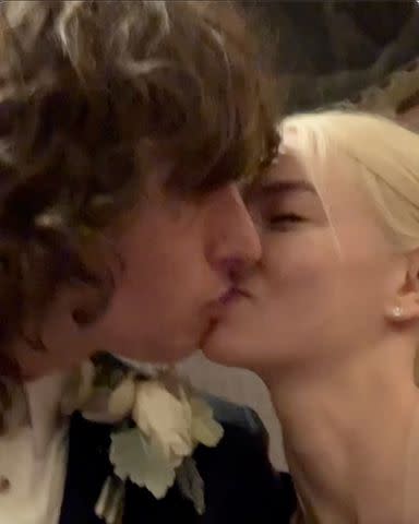 <p>Instagram/malcolmmcrae</p> Malcom McRae and Anya Taylor-Joy kiss on their wedding day