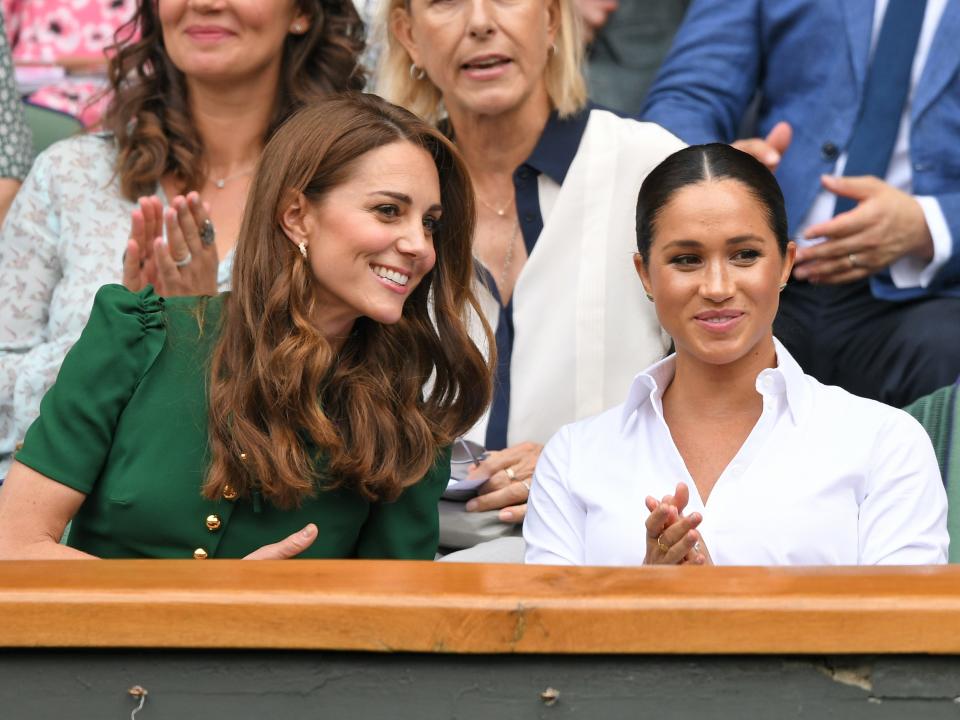 Kate Middleton and Meghan Markle in the Royal Box on Centre Court during day twelve of the Wimbledon Tennis Championships at All England Lawn Tennis and Croquet Club on July 13, 2019 in London, England.