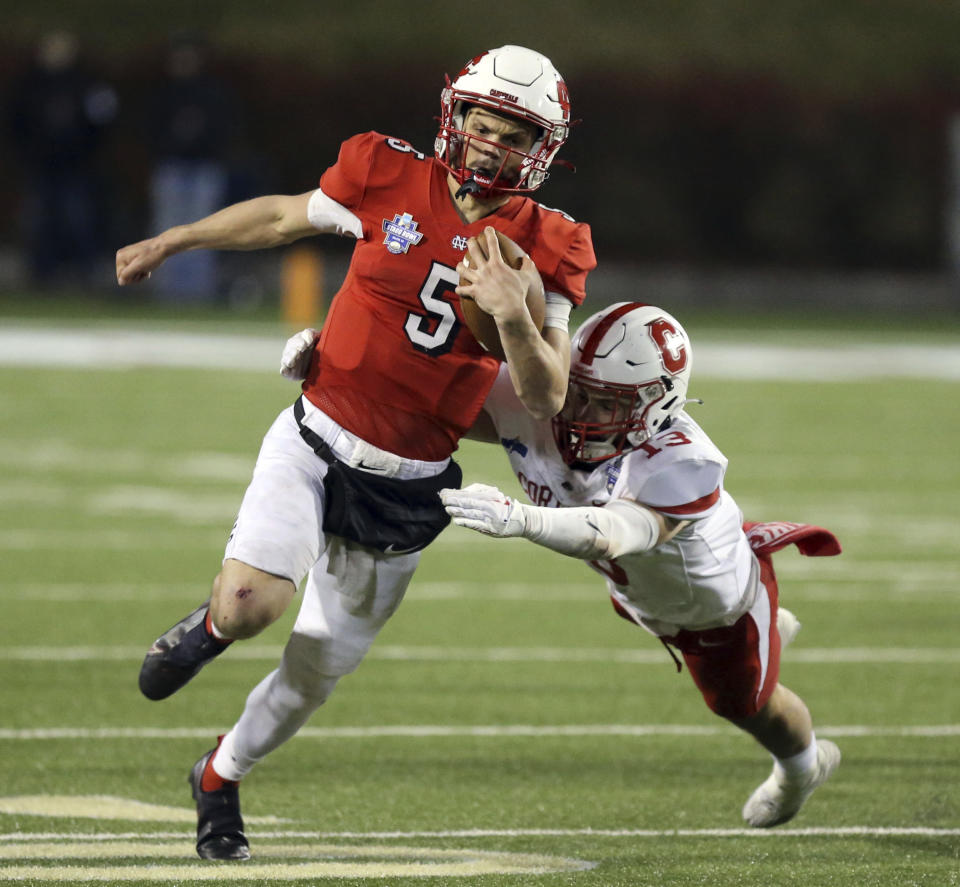 North Central quarterback Luke Lehnen (5) runs for a touchdown past Cortland defender Luke Winslow (13) during the second half of the Amos Alonzo Stagg Bowl NCAA Division III championship football game in Salem, Va., Friday Dec. 15, 2023. (Matt Gentry/The Roanoke Times via AP)