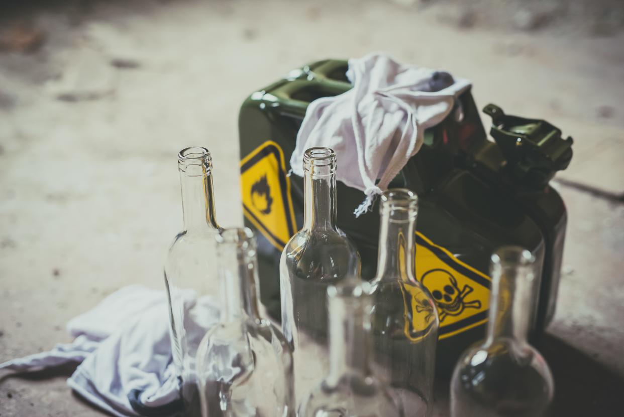 Molotov cocktail. Green military jerrycan with empty bottles and cloth