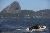 Brazilian marines sail past Sugar Loaf mountain in a speed boat during a military exercise in Guanabara Bay, in Rio de Janeiro, Brazil, Wednesday, Feb. 20 2014. Brazil’s Navy said that the operations being carried out this week in preparation for the 2014 FIFA World Cup are the largest exercises in its history. FIFA director of security Ralf Mutschke has said that FIFA is satisfied with the level of security that will be provided by Brazilian authorities, and guarantees that football's governing body "is highly committed to ensuring the safety and security for fans, players and any other stakeholder involved in our event." (AP Photo/Leo Correa)