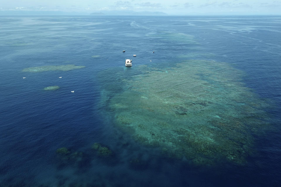 The Remoora pontoon, owned by Reef Magic, sits above the Moore Reef, a section of the Great Barrier Reef in Gunggandji Sea Country off coast of Queensland in eastern Australia on Nov. 14, 2022. The Great Barrier Reef, battered but not broken by climate change impacts, is inspiring hope and worry alike as researchers race to understand how it can survive a warming world. (AP Photo/Sam McNeil)