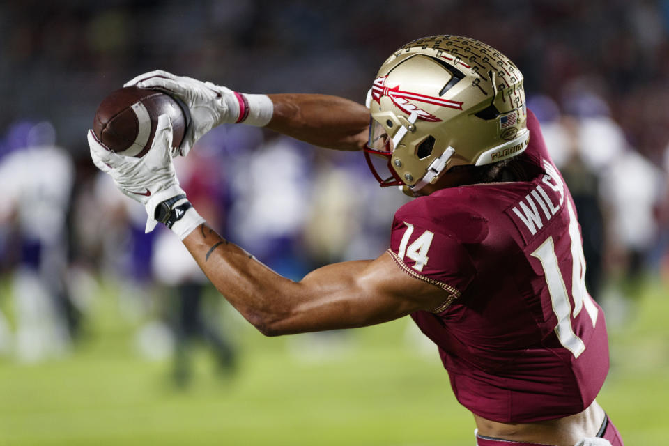 Nov 18, 2023; Tallahassee, Florida, USA; Florida State Seminoles wide receiver Johnny Wilson (14) catches the ball during the warm ups against the <a class="link " href="https://sports.yahoo.com/ncaaf/teams/north-alabama/" data-i13n="sec:content-canvas;subsec:anchor_text;elm:context_link" data-ylk="slk:North Alabama Lions;sec:content-canvas;subsec:anchor_text;elm:context_link;itc:0">North Alabama Lions</a> at Doak S. Campbell Stadium. Mandatory Credit: Morgan Tencza-USA TODAY Sports