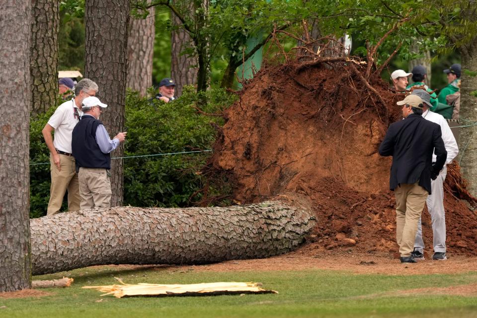 FILE - Apr 7, 2023; Augusta, Georgia, USA; Volunteers and staff secure the area around where a tree fell near the 17th tee during the second round of The Masters golf tournament last year.