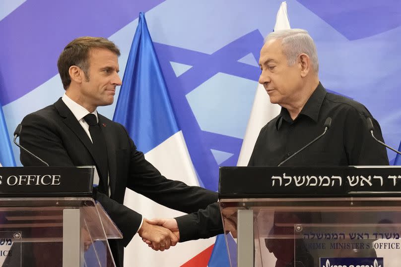 Israeli Prime Minister Benjamin Netanyahu, right, shakes hands with French President Emmanuel Macron during a joint press conference in Jerusalem, Tuesday, Oct. 24, 2023.