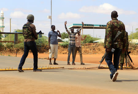 Security officers question civilians at a roadblock near the scene where gunmen abducted two Cuban doctors as they were going to work, in Mandera county, Kenya April 12, 2019. REUTERS/Stringer