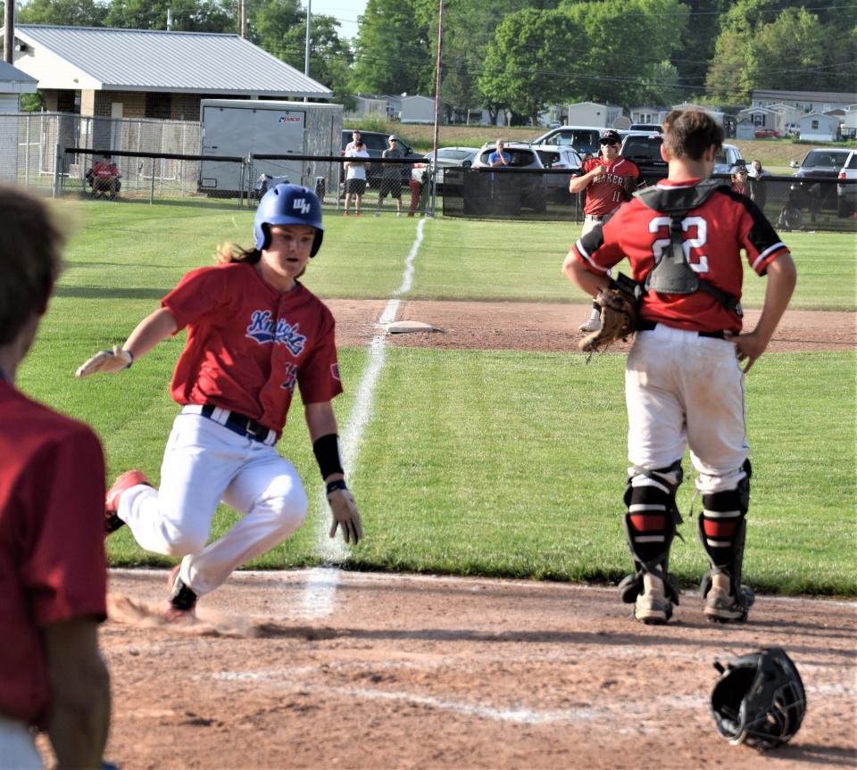 Blake McCombs slides safely into home with West Holmes' lone run in the seventh inning on a single by Brady Smith.