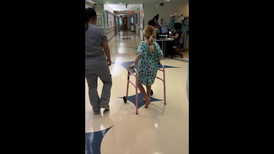 Emma, a 7-year-old Charlotte girl, takes her final walk with a physical therapist at Levine Children’s Hospital in Charlotte, N.C., before being released on Thursday, May 18, 2023.