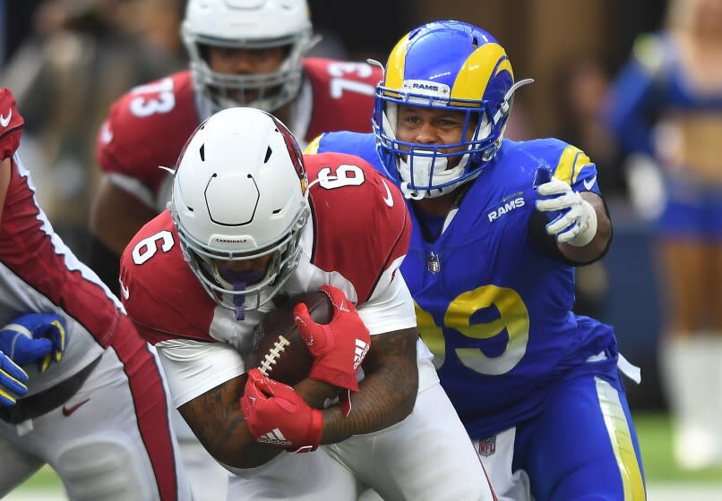 Inglewood, CA. October 3, 2021: Rams Aaron Donald prepares to tackle Cardinals running back James Conner.