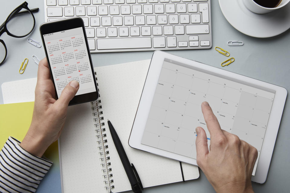 woman looking at a calendar on her desk