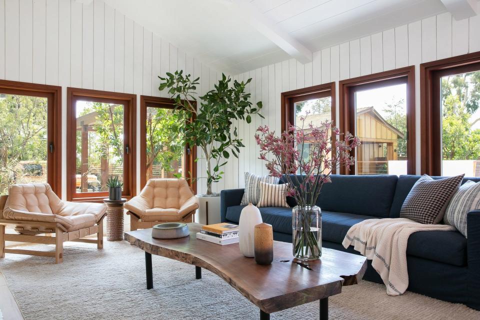 living room with couch and lounge chairs