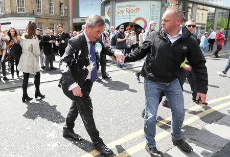 Brexit Party leader Nigel Farage gestures after being hit with a milkshake while arriving for a Brexit Party campaign event in Newcastle, Britain, May 20, 2019. REUTERS/Scott Heppell