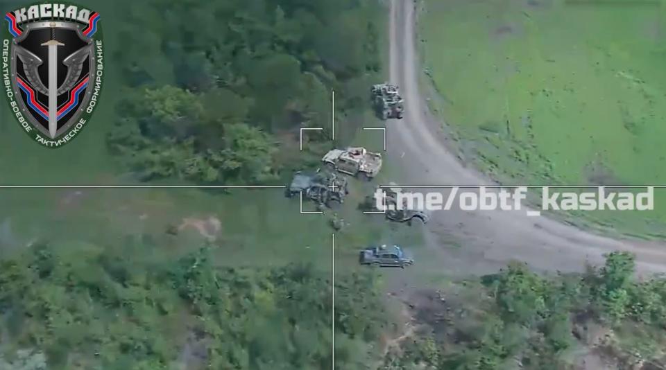 A still image from a video purporting to show Russia's Lancet drones hitting a cluster of vehicles.