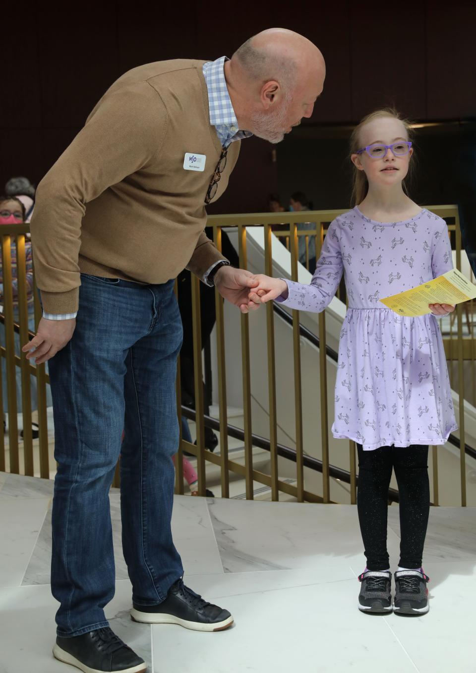 Milwaukee Symphony president Mark Niehaus checks in with Mia Kogler during pre-concert activities before the Milwaukee Symphony's April 3 sensory friendly concert for people on the autism spectrum or with a sensory sensitivity,