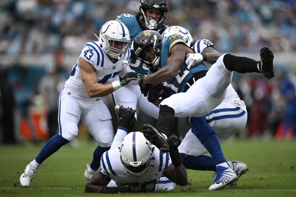 Jacksonville Jaguars tight end Brenton Strange (85) is tackled by Indianapolis Colts' Drew Ogletree (85) during the first half of an NFL football game, Sunday, Oct. 6, 2024, in Jacksonville, Fla. (AP Photo/Phelan M. Ebenhack)