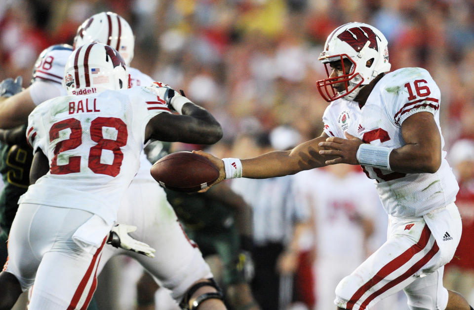 Jan 2, 2012; Pasadena, CA, USA; Wisconsin Badgers quarterback Russell Wilson (16) passes the ball off to Wisconsin Badgers running back Montee Ball (28)against the Oregon Ducks in the 2012 Rose Bowl game at the Rose Bowl. Mandatory Credit: Kelvin Kuo-USA TODAY Sports