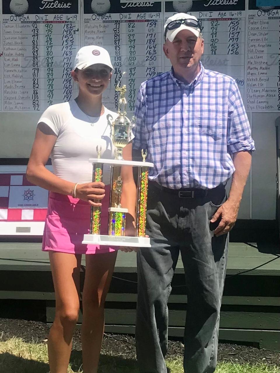 Gary Sims, right, presents Perrysburg's Sydney Deal with her trophy earned at the end of the two-day, 36-hole Ohio Junior Girls Championship completed Tuesday at Marion Country Club.