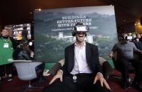 Starbucks employee Ed Devlin reacts as he views a 360 video of a Starbucks' Costa Rica coffee farm at a display before the company's annual shareholder meeting, Wednesday, March 22, 2017, in Seattle. (AP Photo/Elaine Thompson)