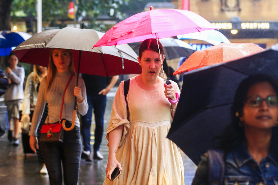 People are seen in Sydney's CBD as rain falls on January 17, 2020 in Sydney, Australia. 