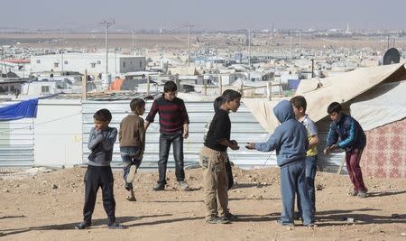 Young Syrian refugees play in the Zaatari Refugee Camp, near the city of Mafraq, Jordan, November 29, 2015. REUTERS/Paul Chiasson/Pool