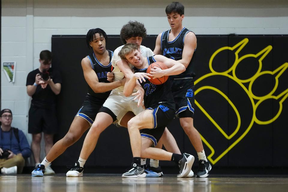 Hilliard Bradley's Garrett Sever (23) fights for the ball with Delaware Hayes' Jake Lowman (14).