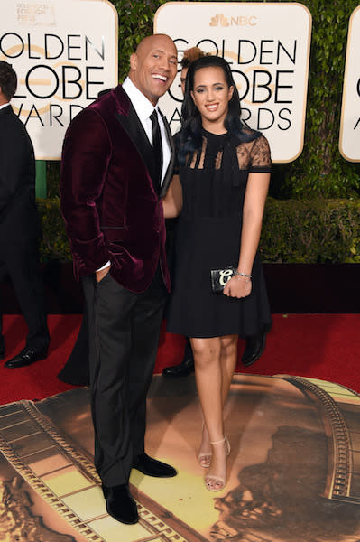 Dwayne “The Rock” Johnson in a maroon velvet tuxedo jacket with black trousers at the 73rd Golden Globe Awards.