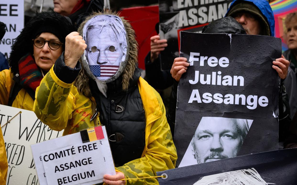 Julian Assange supporters chant and hold placards outside the High Court ahead of the second day of his US extradition case, on Feb 21 in London