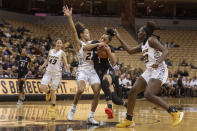 South Carolina's Zia Cooke, center, drives between Missouri's Aijha Blackwell, right, and Jordan Roundtree, left, during the first half of an NCAA college basketball game Thursday, Jan. 16, 2020, in Columbia, Mo. (AP Photo/L.G. Patterson)