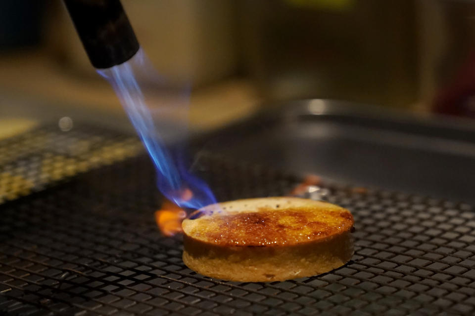 Pastry chef Vince Bugtong prepares a Crème Brûlée Tart, made of lemon cinnamon custard, strawberry guava jam, macadamia coconut streusel and ube espuma, a purple yam foam, at Abaca restaurant in San Francisco, Monday, May 29, 2023. Three Filipino restaurants in three different areas of the U.S. will be representing at this year's James Beard Awards, the culinary world's equivalent of the Oscars. The awards ceremony is next week in Chicago. (AP Photo/Jeff Chiu)