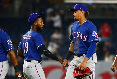 Aug 10, 2018; Bronx, NY, USA; Texas Rangers first baseman Ronald Guzman (right) is congratulated by Texas Rangers designated hitter Jurickson Profar (19) after defeating the New York Yankees at Yankee Stadium. Mandatory Credit: Andy Marlin-USA TODAY Sports