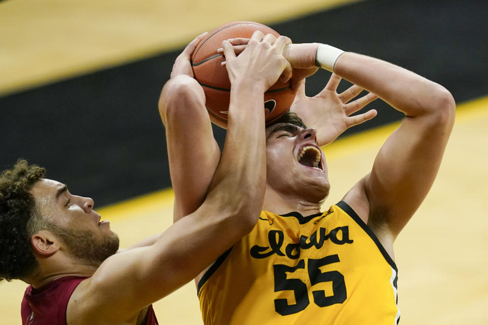 Indiana forward Race Thompson fights for a rebound with Iowa center Luka Garza (55) during the second half of an NCAA college basketball game, Thursday, Jan. 21, 2021, in Iowa City, Iowa. Indiana won 81-69. (AP Photo/Charlie Neibergall)