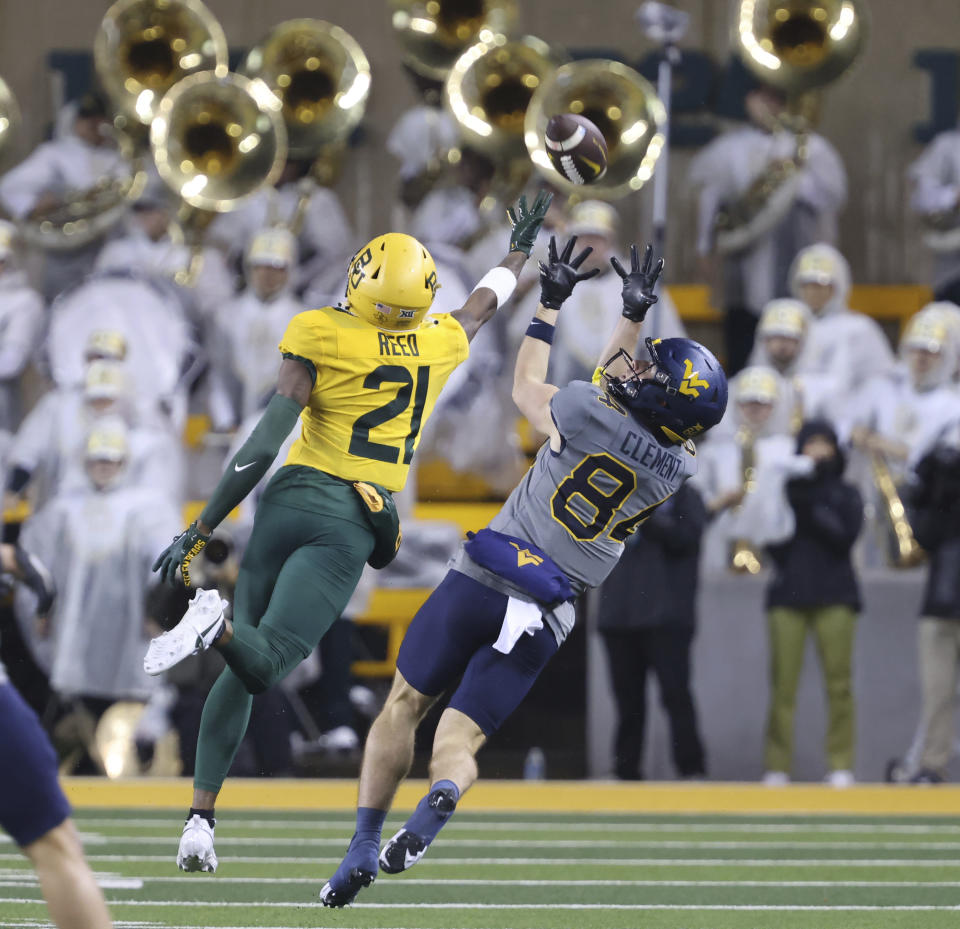 West Virginia wide receiver Hudson Clement, right, pulls down a long pass over Baylor cornerback Chateau Reed, left, in the first half of an NCAA college football game, Saturday, Nov. 25, 2023, in Waco, Texas. (Rod Aydelotte/Waco Tribune-Herald, via AP)