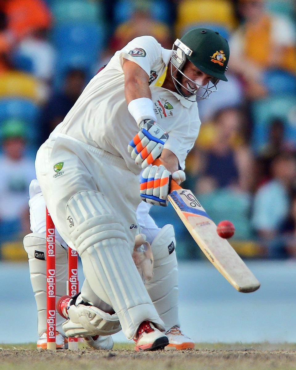 Australian batsman Michael Hussey hits a boundary off West Indies bowler Narsingh Deonarine during the final day of the first-of-three Test matches between Australia and West Indies at the Kensington Oval stadium in Bridgetown on April 11, 2012. Australia is chasing a target of 192 runs to win the match. AFP PHOTO/Jewel Samad (Photo credit should read JEWEL SAMAD/AFP/Getty Images)