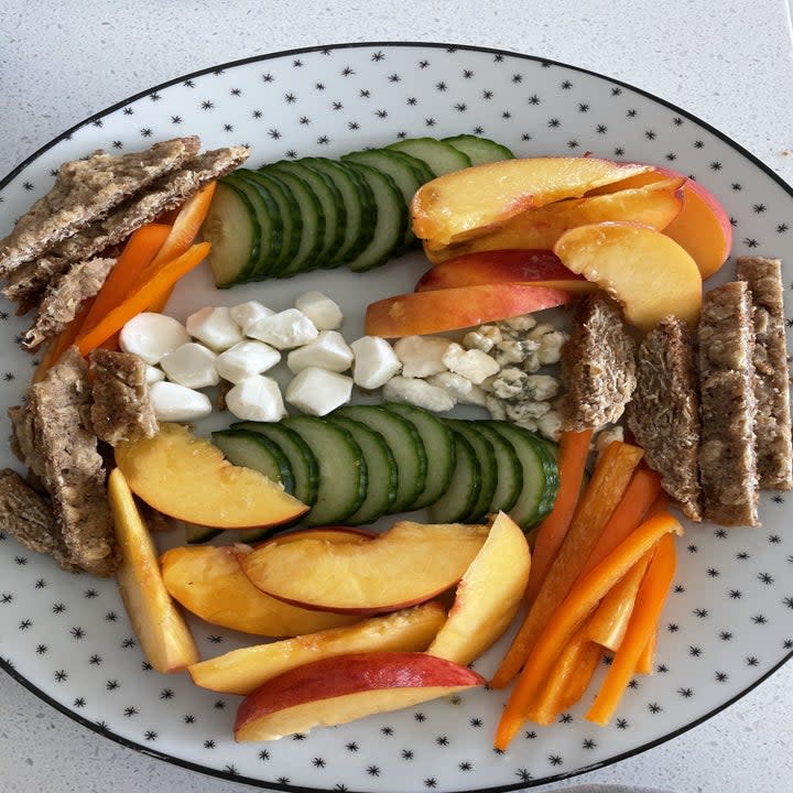 snacking plate with fruit, vegetables, and cheese