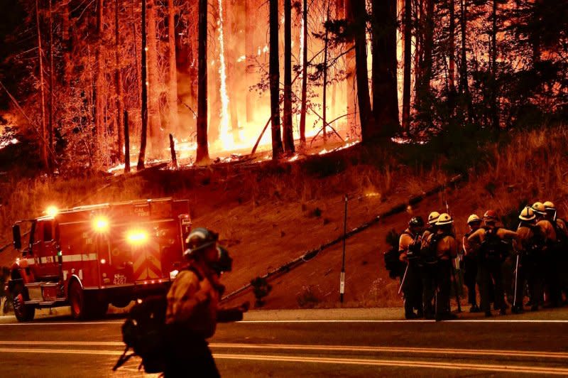 Firefighters wait for supplies and orders before attacking the Park Fire, which has burned 383,619 acres Tuesday according to the California Department of Forestry and Fire Protection (Cal Fire), in Tehama County, Calif. Butte County District Attorney Mike Ramsey says a 42-year-old man from Chico was arrested for allegedly pushing a burning car into a gully which set off the Park Fire. As of Tuesday, according to Cal Fire, the fire was 14% contained. Photo by John G. Mabanglo/EPA-EFE