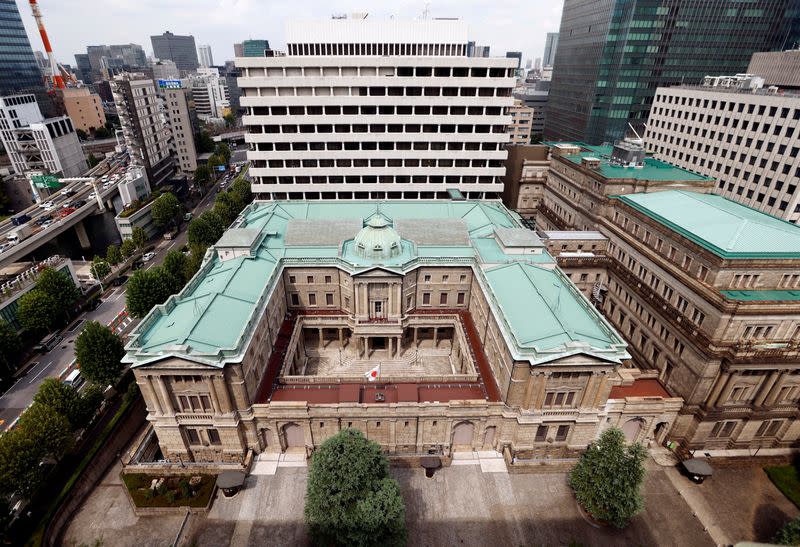 FILE PHOTO: Japanese national flag is hoisted atop the headquarters of Bank of Japan in Tokyo