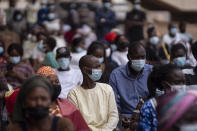 FILE- In this Wednesday, July 28, 2021 file photo, people wait to be vaccinated J at Leopold Sedar Senghor stadium in Dakar, Senegal. Thousands of new coronavirus cases have been reported in West Africa in recent weeks amid low vaccination rates and the spread of the delta variant. (AP Photo/Leo Correa, File)