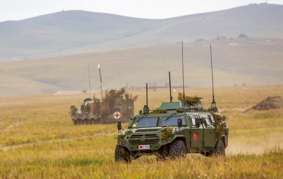 In this photo provided by Russian Defense Ministry Press Service on Tuesday, Sept. 11, 2018, Chinese military vehicles through a field in the Chita region, Eastern Siberia, during the Vostok 2018 exercises in Russia. Russia's military chief of staff says that the military exercises expected to be the biggest in three decades, will involve nearly 300,000 troops. (Russian Defense Ministry Press Service pool photo via AP)