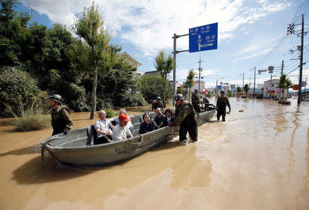 Japan Self-Defense Force soldiers rescue people from a flooded area in Mabi town in Kurashiki, Okayama Prefecture, Japan, July 8, 2018. REUTERS/Issei Kato