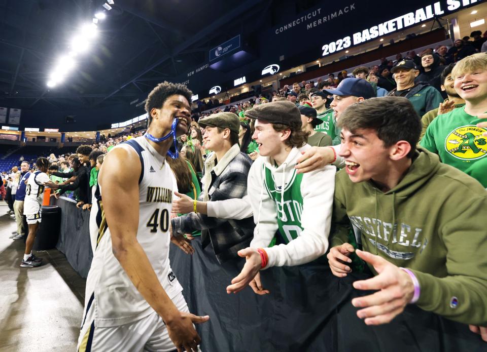 Archbishop Williams Lorenzo Jackson celebrates with students at the conclusion of their MIAA Division 3 title game versus St. Mary's at the Tsongas Center in Lowell on Saturday, March 18, 2023.    
