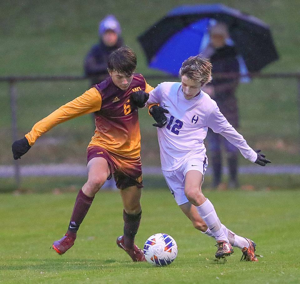 Walsh Jesuit's Ryan Robusto, left, and Hoban's Jared Bendo battle for possession in a Division I sectional game on Tuesday, Oct. 18, 2022 in Cuyahoga Falls.