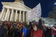 <p>Jennyerin Steele Staats, a special education teacher from Jackson County holds her sign aloft outside of the capitol building after WVEA President Dale Lee outlined the terms for ending the walkout on the fourth day of statewide walkouts in Charleston, W.Va., Tuesday, Feb. 27, 2018. (Photo: Craig Hudson/Charleston Gazette-Mail via AP) </p>