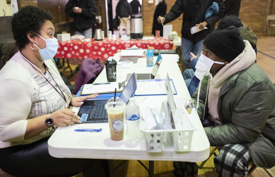 Angelique Ericson, left, with the Columbus Coalition for the Homeless, asks Antjuan Muhammad a set of survey questions at the Broad Street United Methodist Church in January as part of Community Shelter Board's annual count of homeless people in Franklin County.
