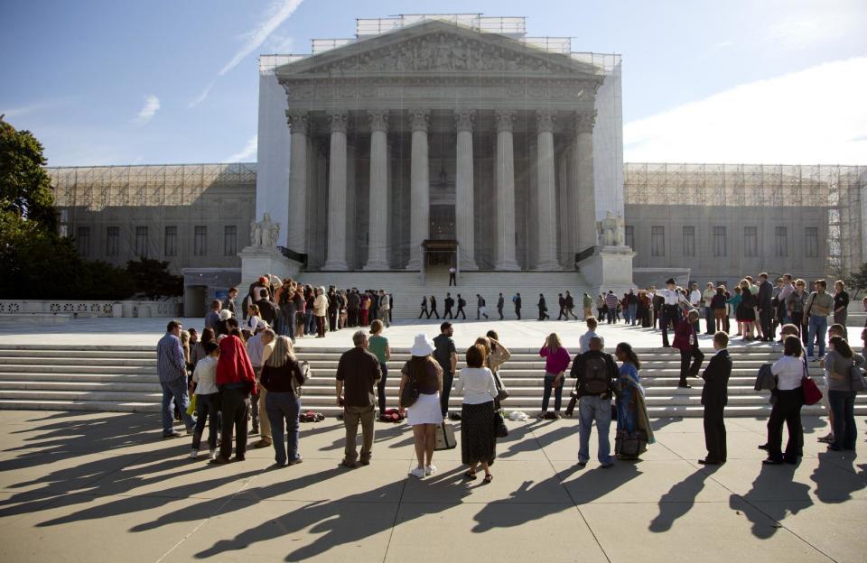 People wait in line to enter the Supreme Court in Washington, Monday, Oct. 1, 2012. The Supreme Court is embarking on a new term that could be as consequential as the last one with the prospect for major rulings about affirmative action, gay marriage and voting rights. (AP Photo/Carolyn Kaster)