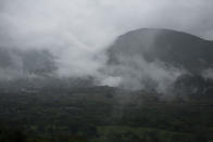 Rain clouds hover over mountains during tropical storm Amanda in Barberena, eastern Guatemala, Sunday, May 31, 2020. The first tropical storm of the Eastern Pacific season drenched parts of Central America on Sunday and officials in El Salvador said at least seven people had died in flooding. (AP Photo/Moises Castillo)